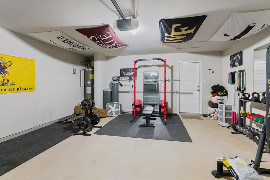 Finished garage interior with light-toned concrete flooring and white walls Finished garage interior with light-toned concrete flooring and white walls