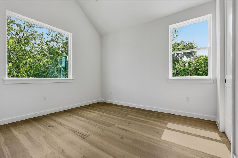 Upstairs secondary bedroom, engineered wood flooring.