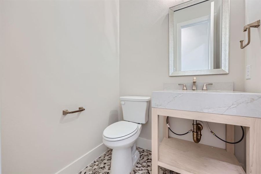 Bathroom with vanity, toilet, and tile patterned flooring