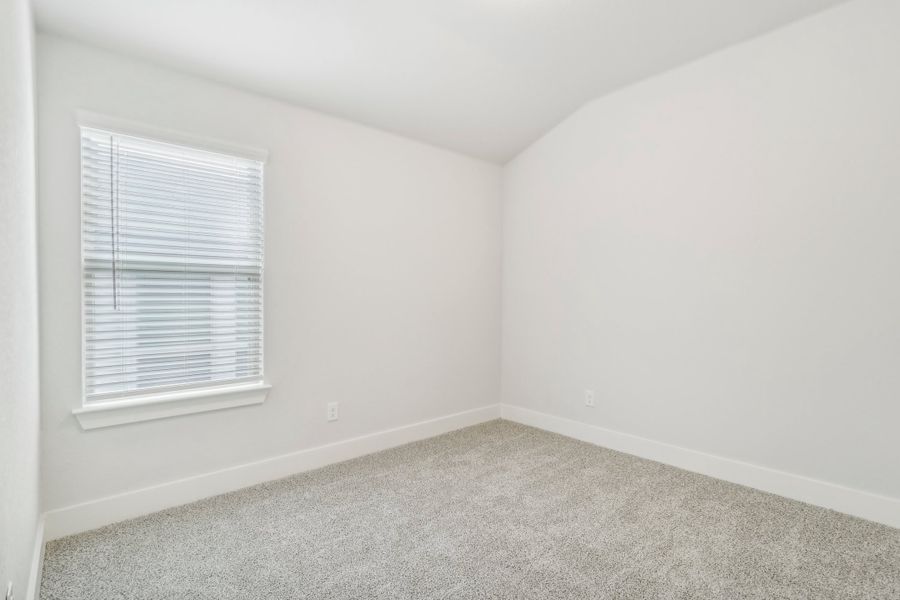 Guest bedroom in the Hughes floorplan at a Meritage Homes community.