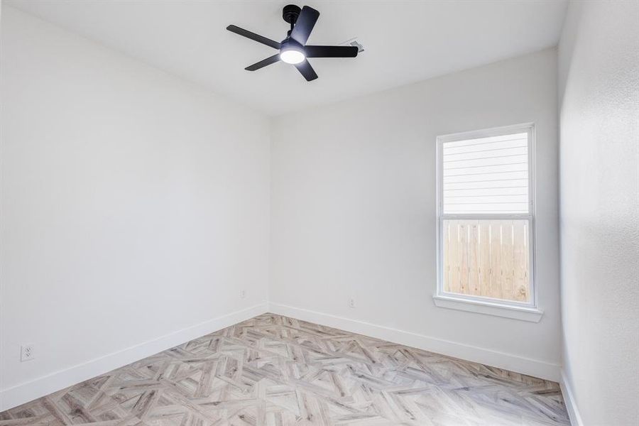 Unfurnished room featuring light parquet floors and ceiling fan