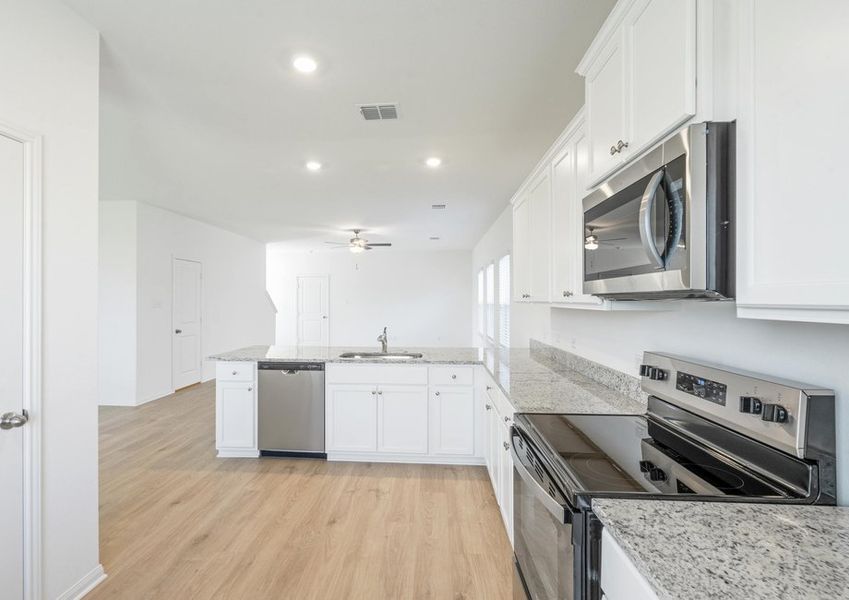 Kitchen with white cabinets, granite countertops and stainless steel appliances