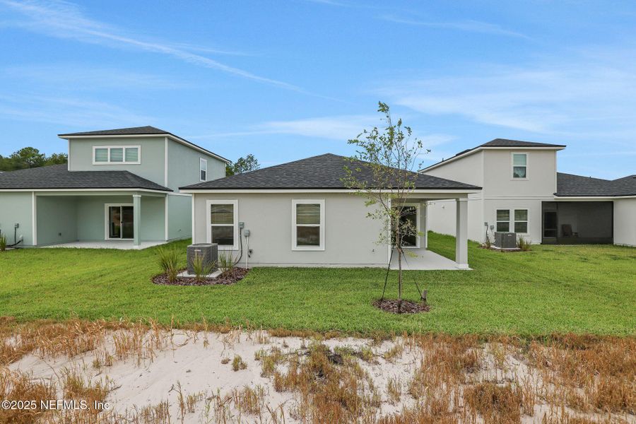 Front exterior of a new home in Bellbrooke, Jacksonville, FL, highlighting curb appeal (Image 15).