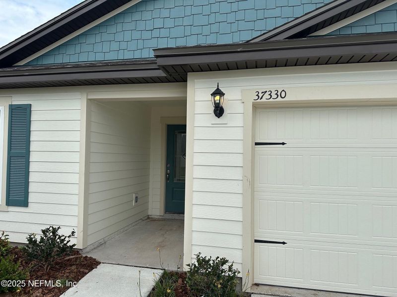 Front exterior of a new home in Whisper Ridge, Hilliard, FL, highlighting curb appeal (Image 1).