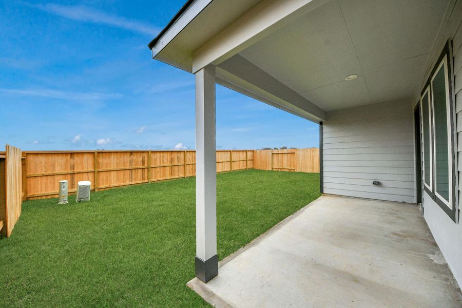 Experience outdoor living at its finest on this expansive covered patio, thoughtfully designed for BBQs and delightful outdoor dining.