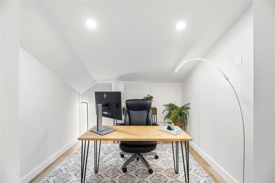This was a brilliant use of space and offers a cozy, modern office space that is well-lit with recessed lighting.