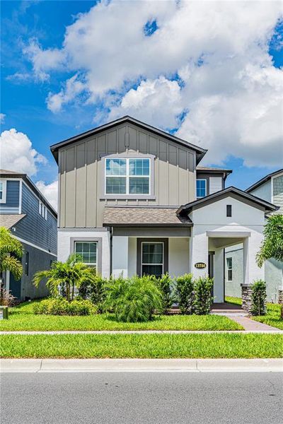 Front exterior of a new home in Encore at Ovation, Winter Garden, FL, highlighting curb appeal (Image 24).