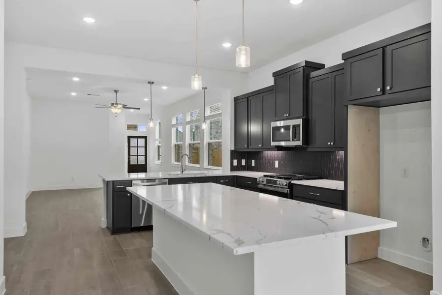 Representative furnished interior of a home built from the Carlisle by Chesmar Homes in Sunterra, Katy (Image 4).
