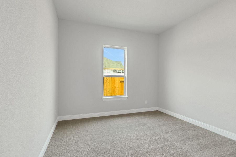 Unfurnished room with baseboards and carpet