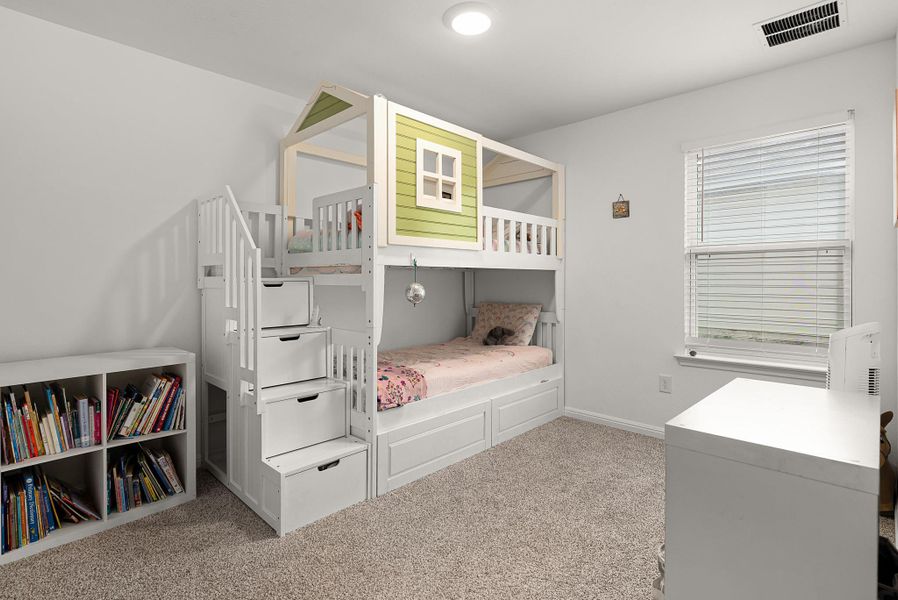 Bedroom with light carpet and baseboards