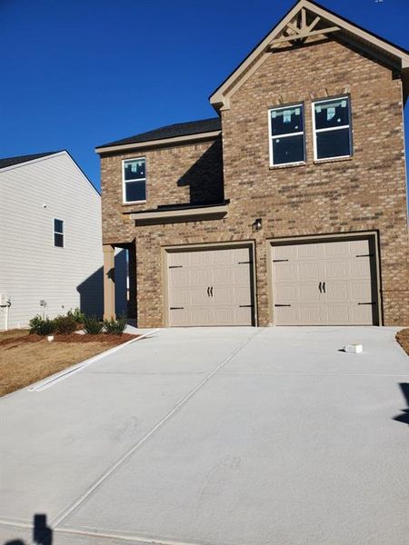 Front exterior of a new home in Creekbend Overlook, South Fulton, GA, highlighting curb appeal (Image 1). Front exterior of a new home in Creekbend Overlook, South Fulton, GA, highlighting curb appeal (Image 1).