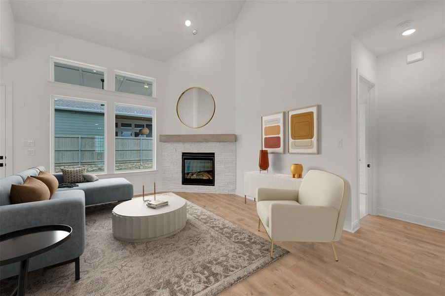 Living area featuring light wood flooring, a fireplace with a white brick surround and wooden mantel, and a high vaulted ceiling