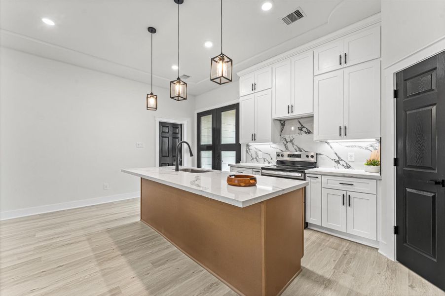 Spacious kitchen featuring abundant cabinetry, center island, and plenty of counter space for meal prep and gatherings. Photos are representative of the same floor plan built by this builder. Finishes will be the same or similar.
