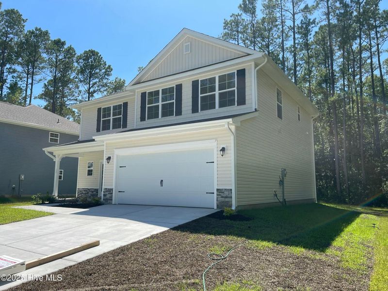 Front exterior of a new home in Mill Creek Cove, Bolivia, NC, highlighting curb appeal (Image 16).