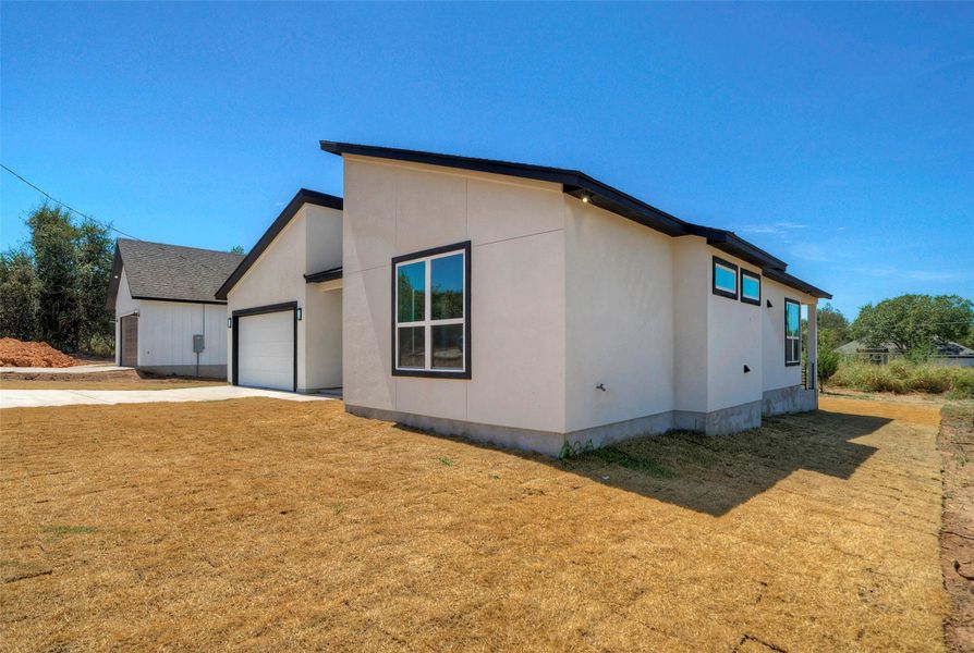 Clean modern architectural lines define this single-family home with stucco siding and a concrete driveway. Clean modern architectural lines define this single-family home with stucco siding and a concrete driveway.