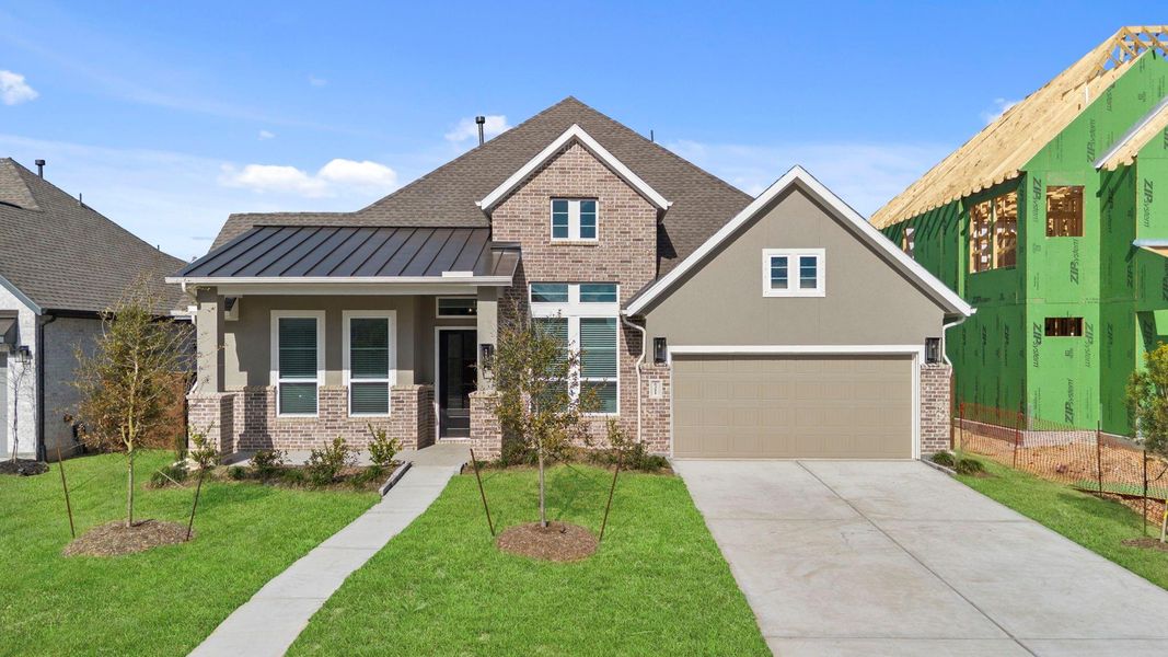 Front exterior of a new home in Meridiana, Manvel, TX, highlighting curb appeal (Image 18).