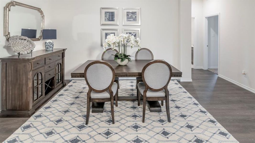 Dining space with baseboards and dark wood-style floors
