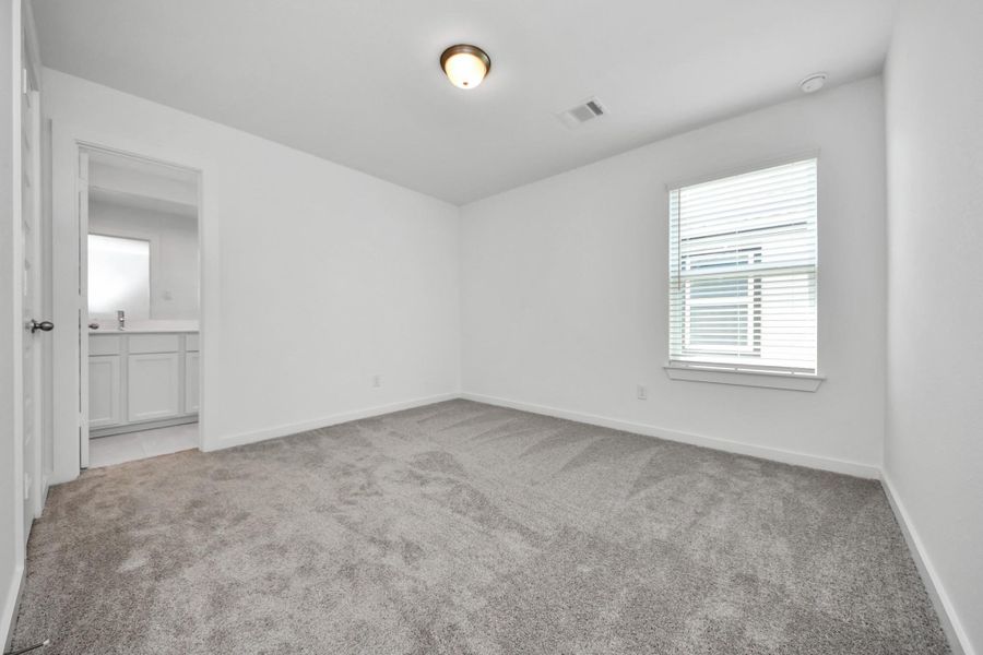 Generously sized secondary bedrooms featuring spacious closets, soft and inviting carpeting underfoot, large windows allowing plenty of natural light, and the added touch of privacy blinds for your personal retreat. Sample photo of completed home with similar floor plan. Actual colors and selections may vary.