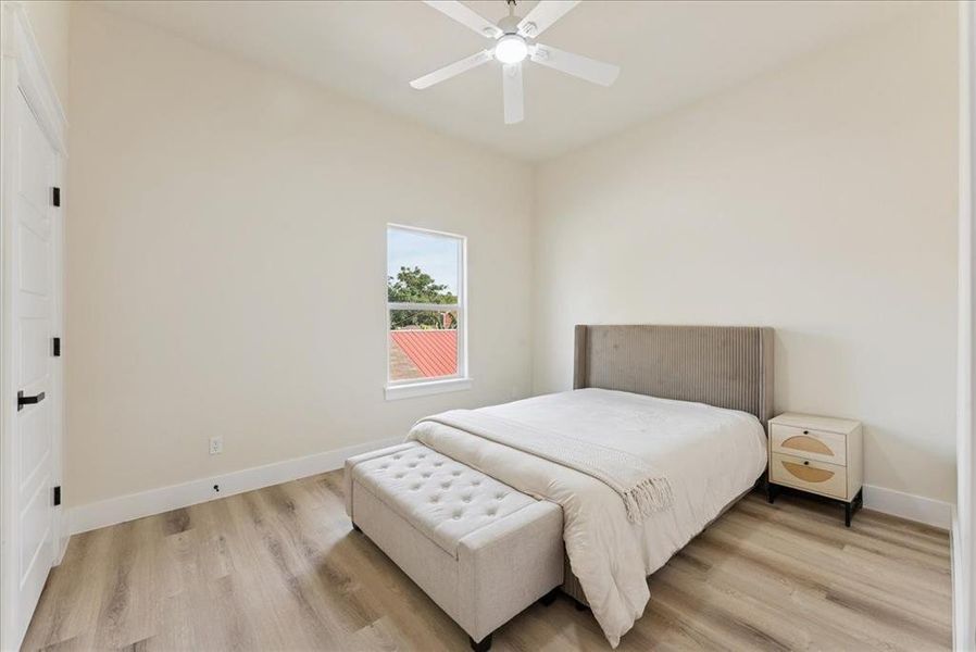 Bedroom with light wood-type flooring and ceiling fan