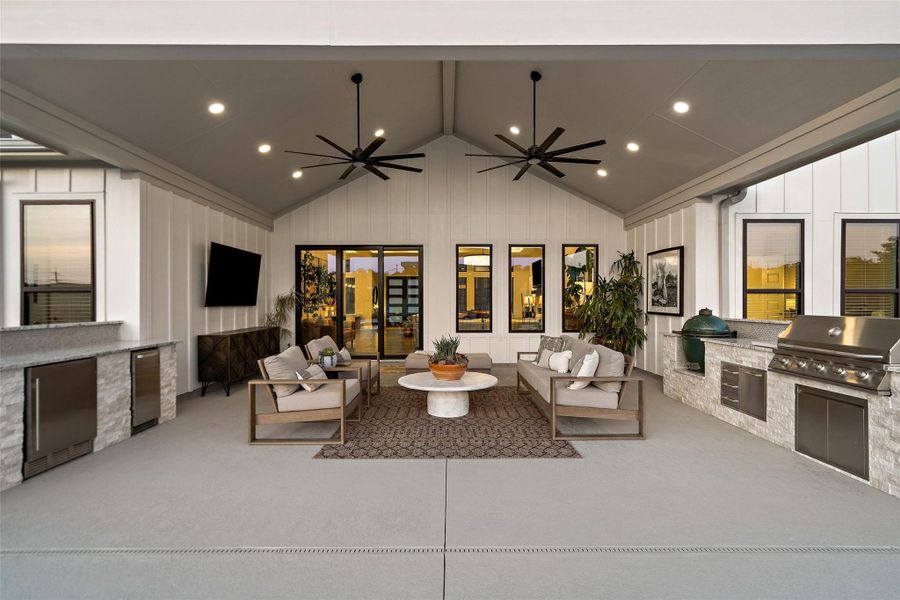 An inviting outdoor living area features a full kitchen and spacious seating for effortless entertaining. An inviting outdoor living area features a full kitchen and spacious seating for effortless entertaining.