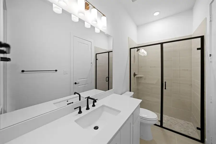 Full bathroom featuring vanity and a stall shower Full bathroom featuring vanity and a stall shower