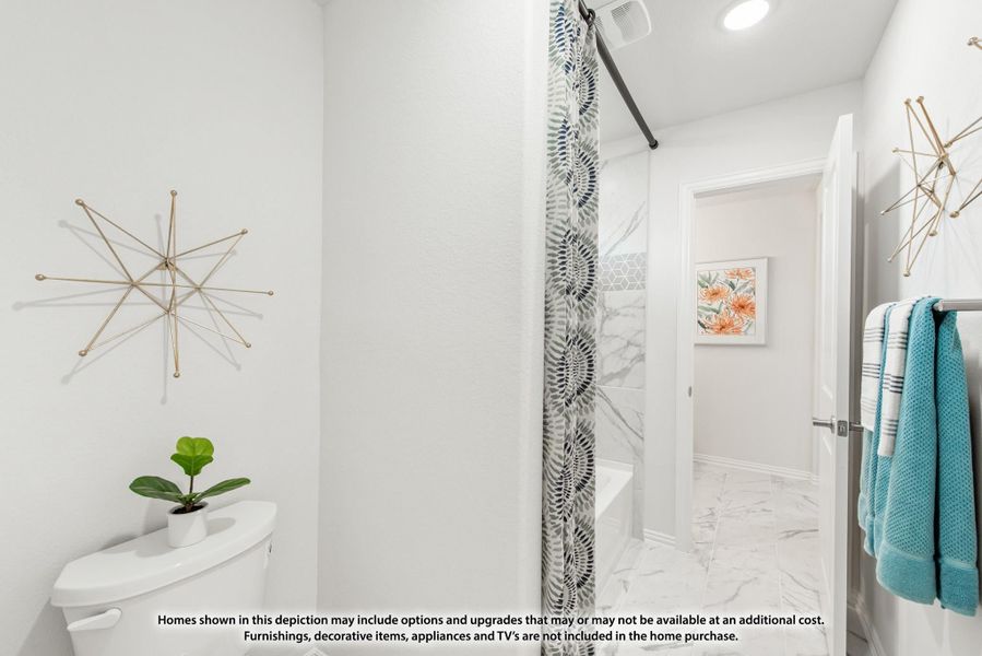 Bathroom with white walls, marble tile floors, patterned shower curtain, and teal towels on a wall rack. Bathroom with white walls, marble tile floors, patterned shower curtain, and teal towels on a wall rack.