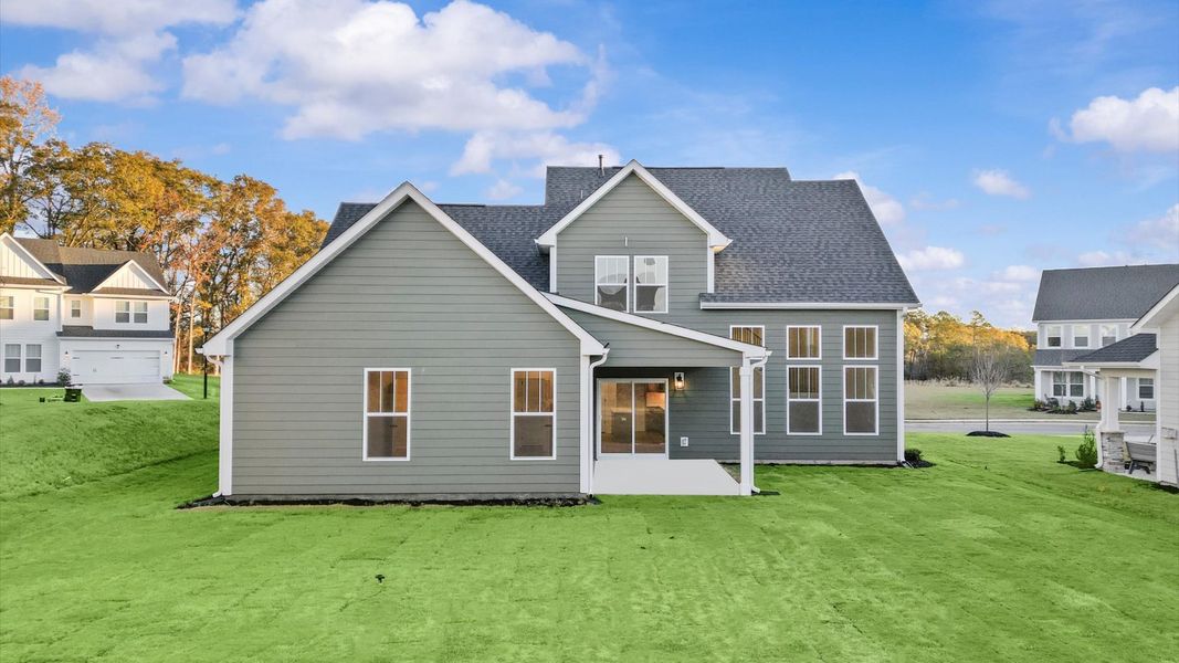 Rear covered porch creates a seamless extension of this home’s elegant design