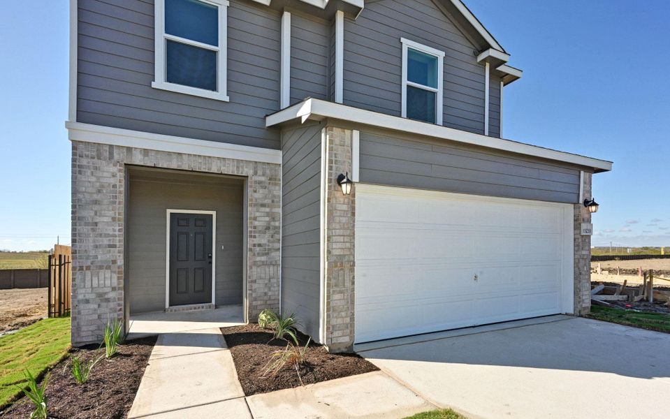 Front exterior of a new home in Stoney Chase, Del Valle, TX, highlighting curb appeal (Image 21).