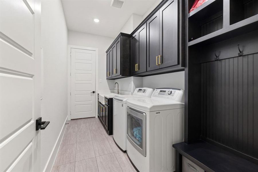 Washroom with washer and clothes dryer, cabinet space, and recessed lighting
