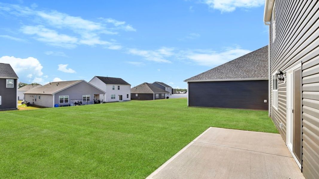 Exterior details and patio area of a home in Durbin Meadows Traditions, Fountain Inn (Image 19).