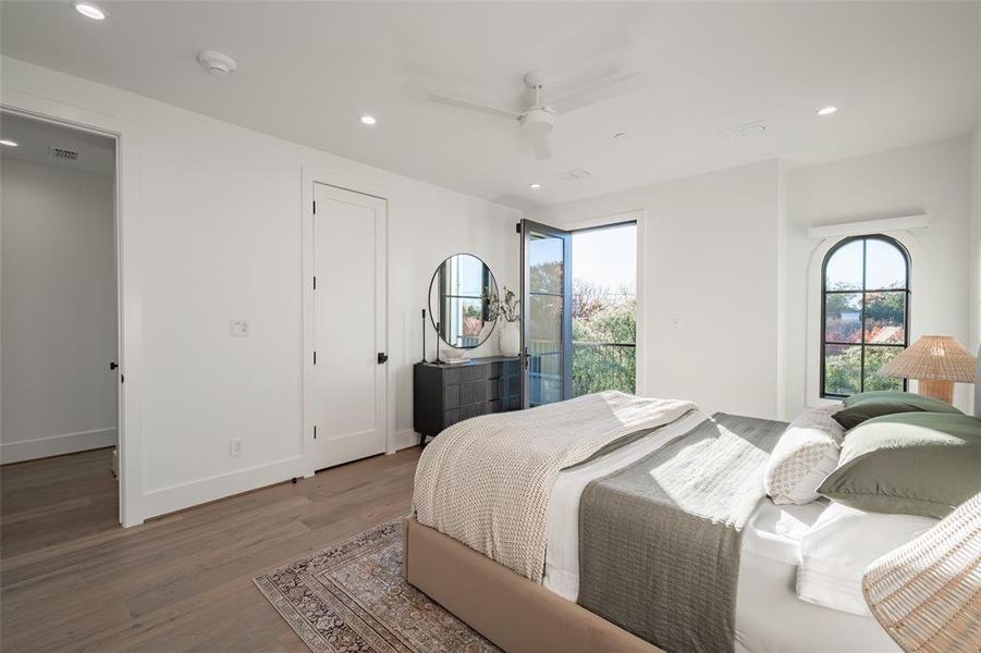 Bedroom featuring hardwood / wood-style floors, access to outside, and ceiling fan