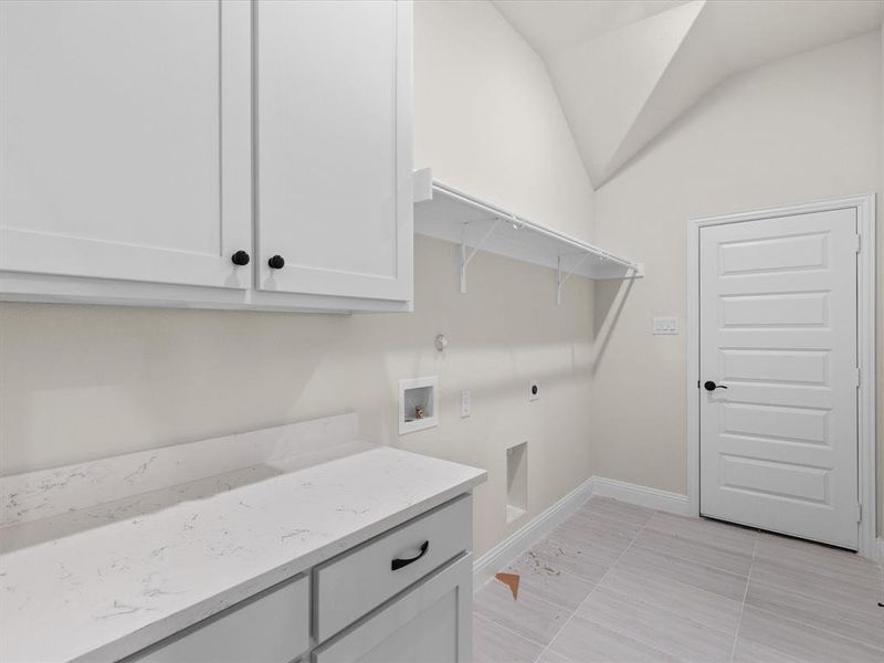 Laundry room with washer hookup, electric dryer hookup, cabinet space, and lofted ceiling