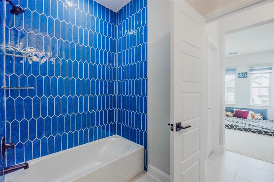 Full bath with tile patterned flooring, visible vents, and bathtub / shower combination