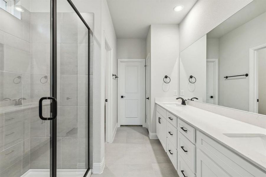 Dual vanity with white cabinetry and integrated sinks Dual vanity with white cabinetry and integrated sinks