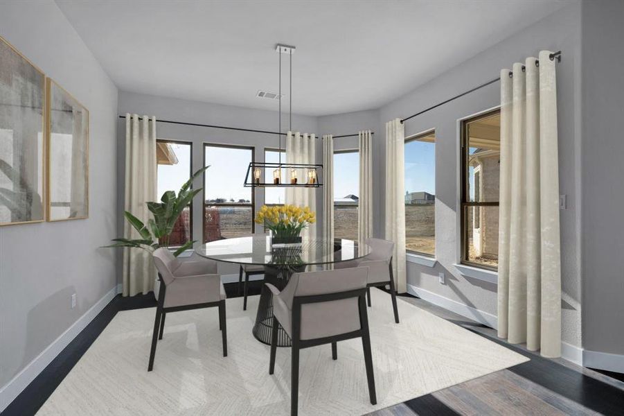 Dining space featuring hardwood / wood-style flooring, a healthy amount of sunlight, and an inviting chandelier