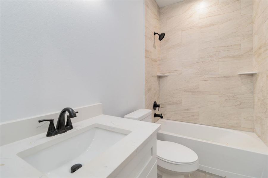 Second full bathroom with tiled shower/tub combo