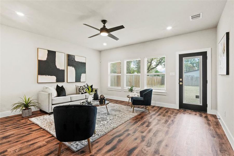 Living area featuring dark wood-type flooring, recessed lighting, and ceiling fan Living area featuring dark wood-type flooring, recessed lighting, and ceiling fan