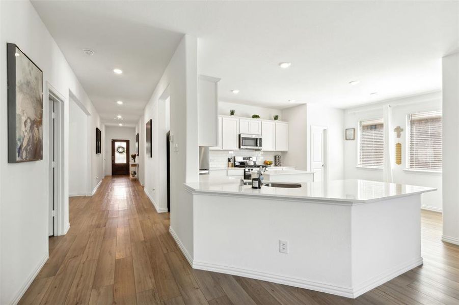 Upgraded kitchen with quartz counters, lots of cabinets and stainless steel appliances.