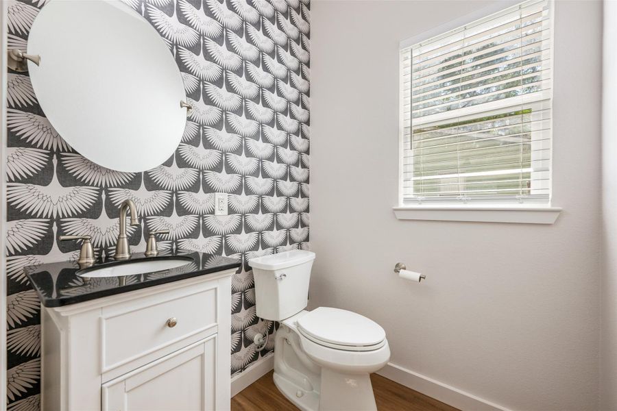 Bathroom featuring vanity and dark wood-type flooring