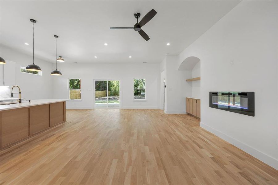 The dining area seamlessly flows into the living space, while a sliding glass door and expansive windows invite abundant natural light and create a connection between the indoors and the outdoors. The dining area seamlessly flows into the living space, while a sliding glass door and expansive windows invite abundant natural light and create a connection between the indoors and the outdoors.
