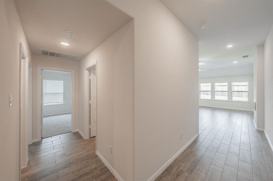 Hall with wood finished floors and recessed lighting Hall with wood finished floors and recessed lighting