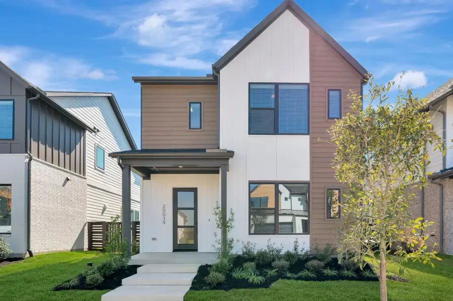 Front exterior of a new home in Bridgeland Central: Emerald Heights - Cottages Row Collection, Cypress, TX, highlighting curb appeal (Image 2). Front exterior of a new home in Bridgeland Central: Emerald Heights - Cottages Row Collection, Cypress, TX, highlighting curb appeal (Image 2).