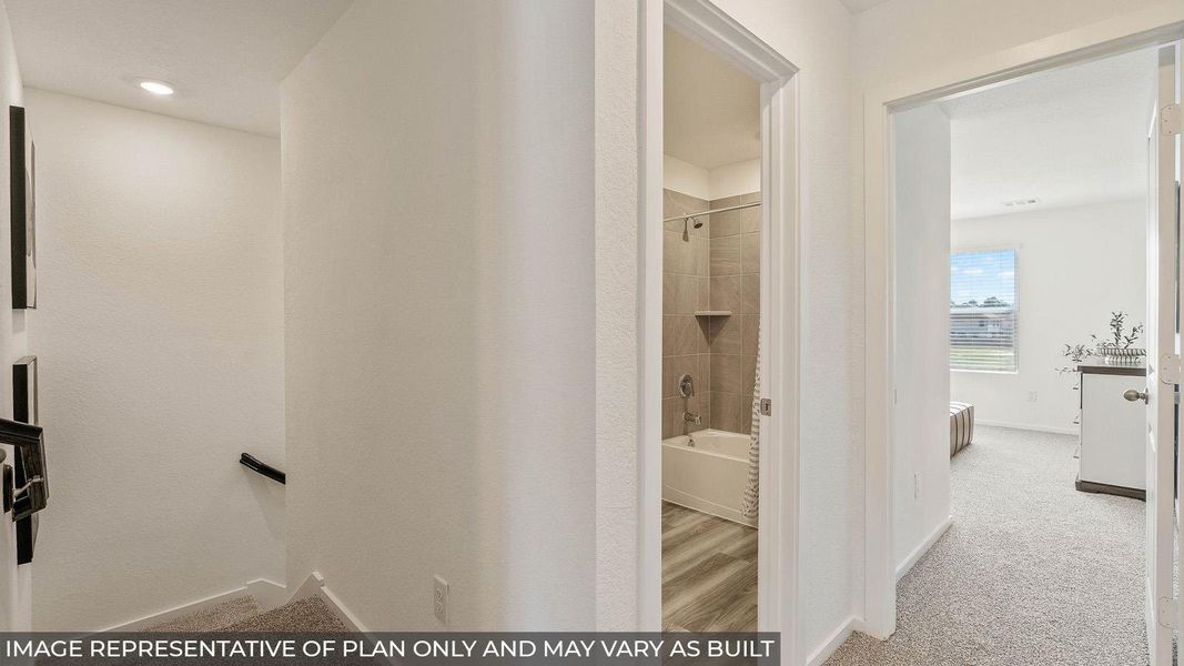 A well-lit hallway connects a contemporary bathroom and a cozy bedroom, blending functional design with comfortable living. A well-lit hallway connects a contemporary bathroom and a cozy bedroom, blending functional design with comfortable living.