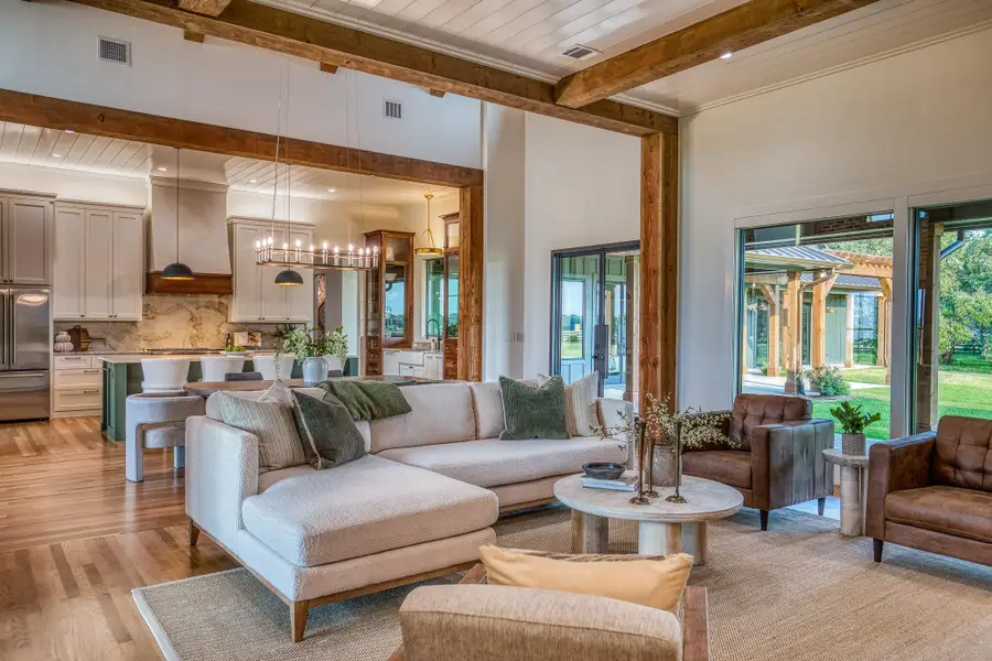 Living area with light wood-type flooring, a wooden ceiling with exposed beams, and a chandelier Living area with light wood-type flooring, a wooden ceiling with exposed beams, and a chandelier