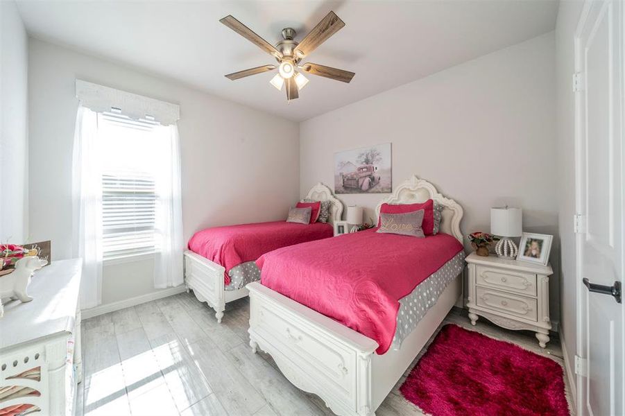 Bedroom featuring ceiling fan and light hardwood / wood-style flooring