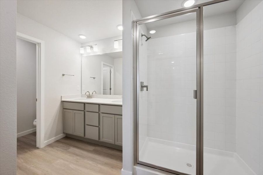 A bathroom with a glass shower. A bathroom with a glass shower.