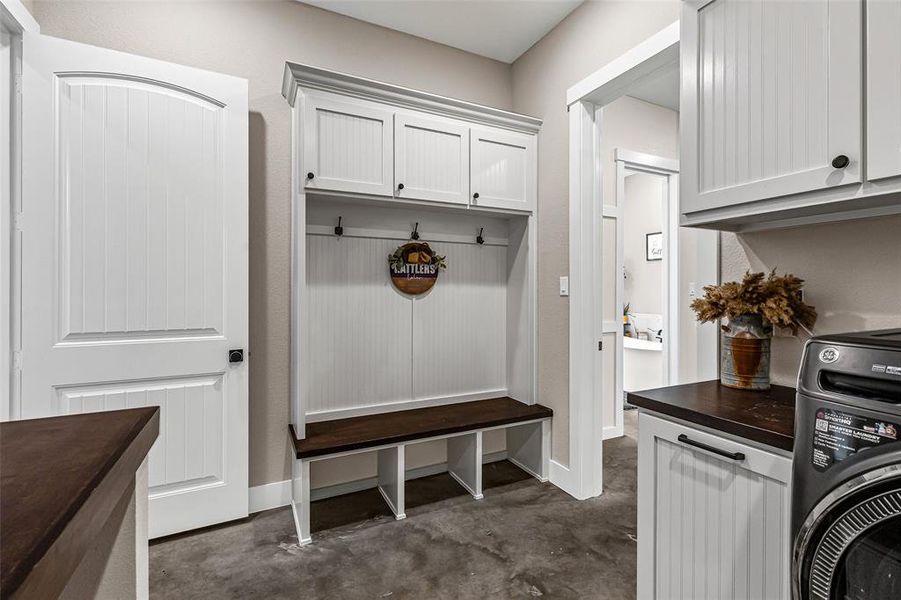 Mudroom with washer / dryer and concrete floors Mudroom with washer / dryer and concrete floors