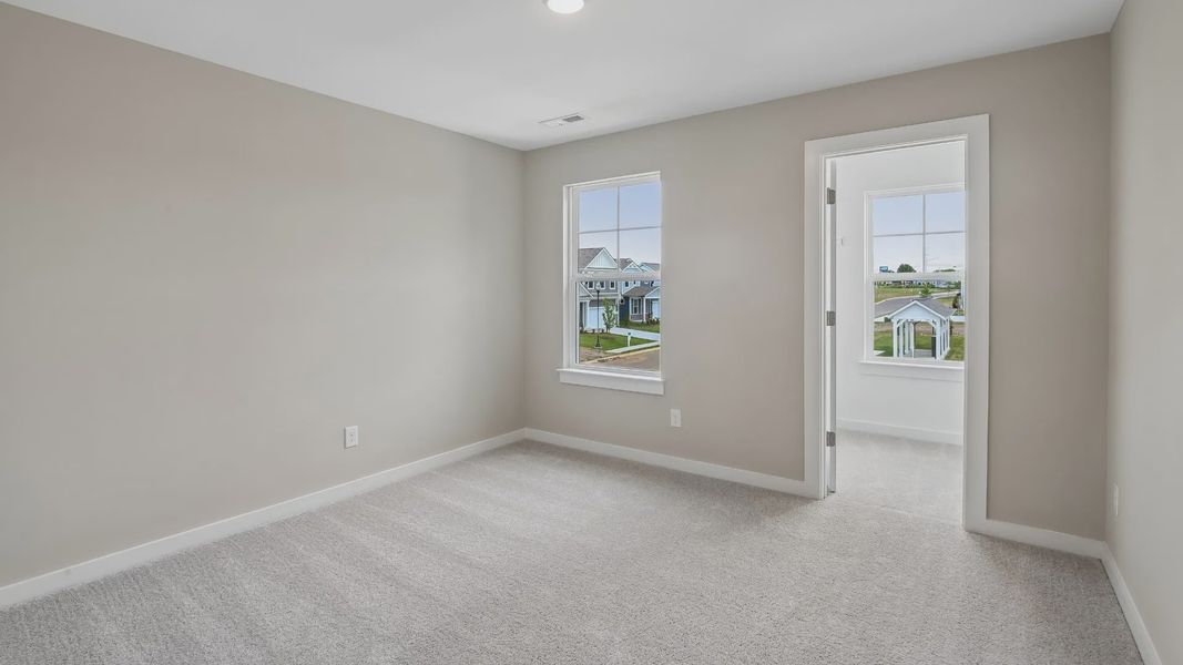 Bedroom with walk-in closet and window Bedroom with walk-in closet and window