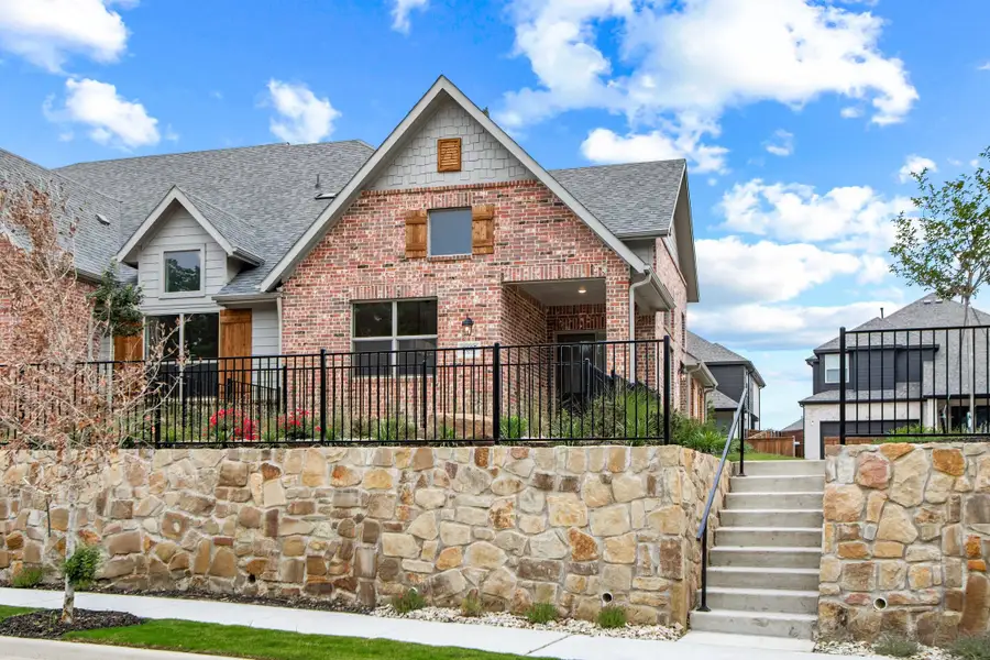 Front exterior of a new home in Cottonwood Creek, Rowlett, TX, highlighting curb appeal (Image 1). Front exterior of a new home in Cottonwood Creek, Rowlett, TX, highlighting curb appeal (Image 1).