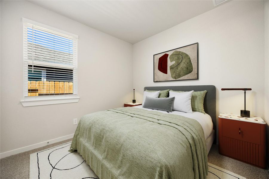 Bright and comfortable, this secondary bedroom offers a calm atmosphere with soft tones, natural light, and cozy carpeting throughout.